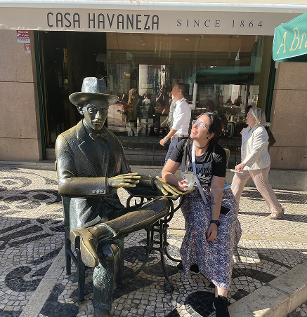 Nessie Loughty posed with a statue